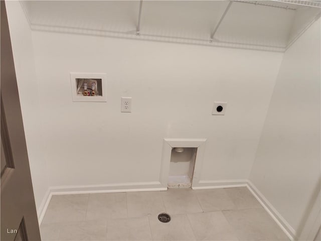 washroom featuring baseboards, light tile patterned floors, hookup for a washing machine, and hookup for an electric dryer