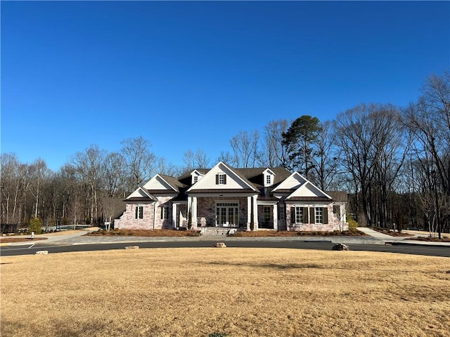 view of front of property with stone siding and a front yard