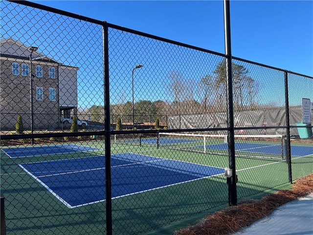 view of sport court featuring fence