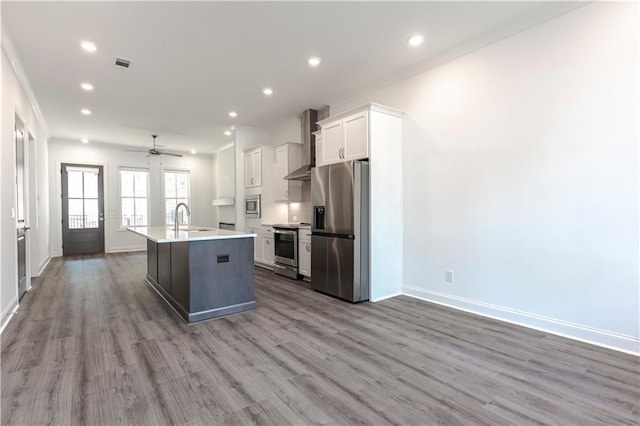 4948 Sudbrook Way, Peachtree Corners, GA 30092 - kitchen featuring visible vents, wall chimney range hood, white cabinetry, a sink, and appliances with stainless steel finishes