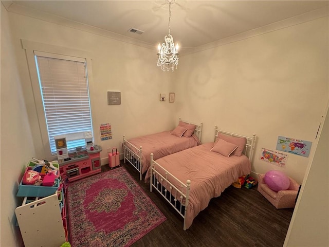 bedroom featuring wood-type flooring, an inviting chandelier, and ornamental molding