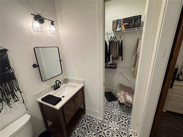 bathroom featuring tile patterned floors, vanity, and toilet