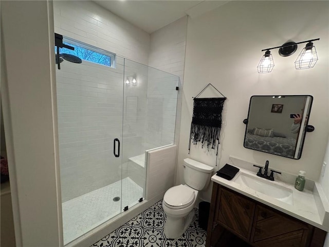 bathroom with vanity, toilet, and an enclosed shower