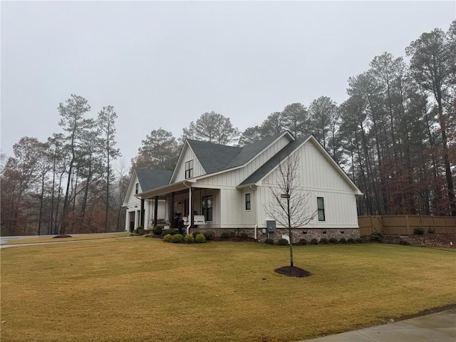 view of property exterior with covered porch and a yard