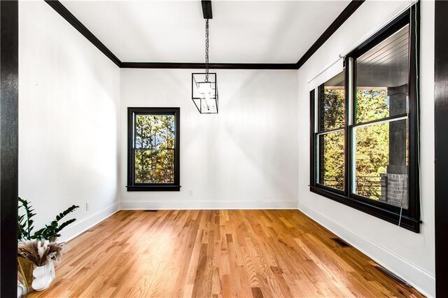 spare room with ornamental molding and plenty of natural light