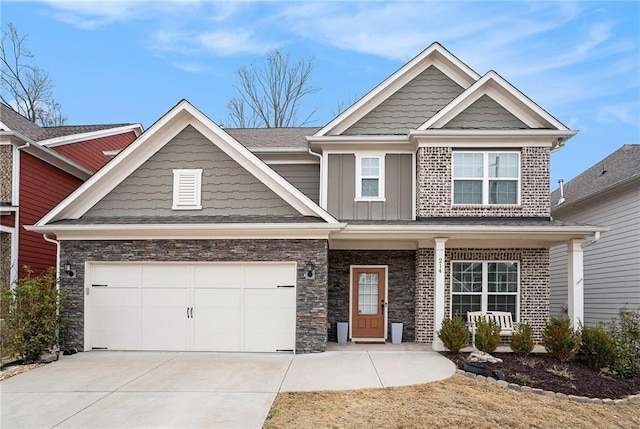 craftsman house with a garage, stone siding, board and batten siding, and concrete driveway