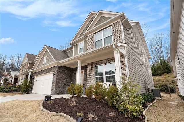 craftsman house featuring a garage, cooling unit, concrete driveway, and brick siding