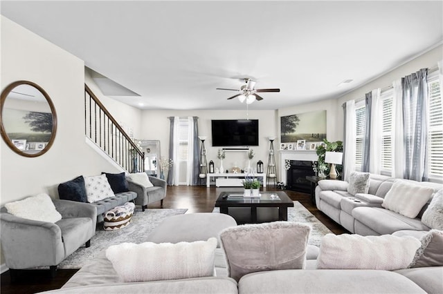 450 Noblewood Dr, Mcdonough, GA 30252 - living room with stairs, dark wood finished floors, a ceiling fan, and a glass covered fireplace