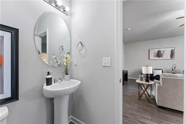 bathroom with ceiling fan, wood-type flooring, and toilet