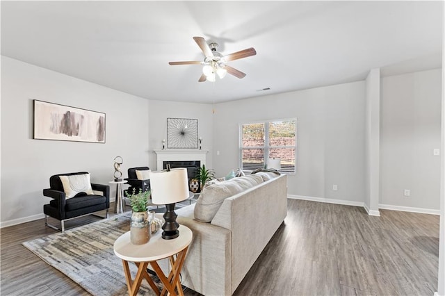 living room featuring hardwood / wood-style floors and ceiling fan