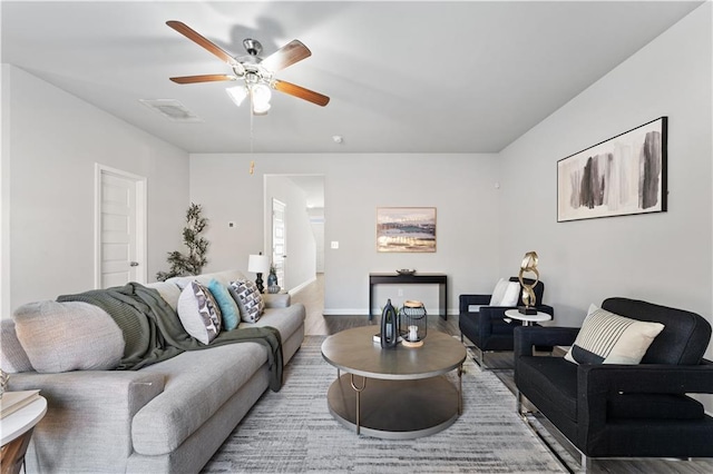 living room featuring ceiling fan and wood-type flooring