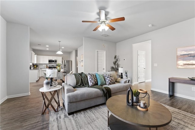 living room featuring hardwood / wood-style floors and ceiling fan