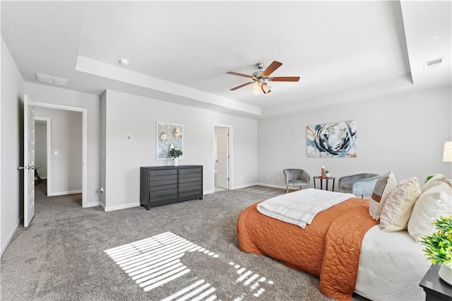 bedroom with carpet, a tray ceiling, and ceiling fan