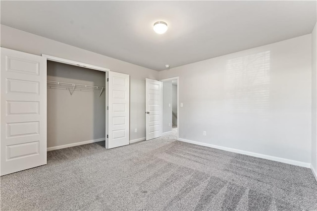 unfurnished bedroom featuring carpet and a closet