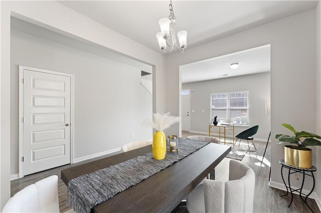 dining area featuring a notable chandelier and dark hardwood / wood-style flooring