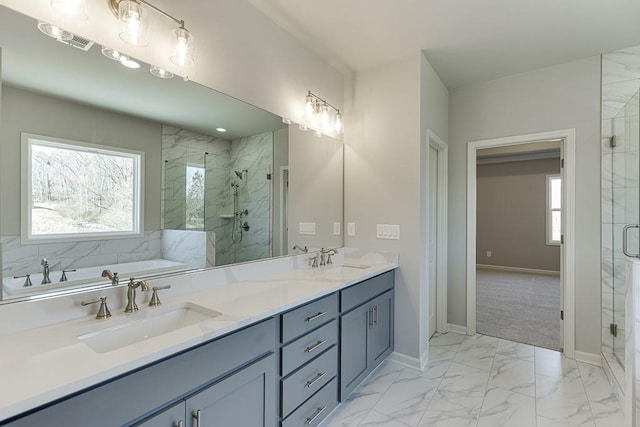 full bathroom featuring marble finish floor, a stall shower, and a sink