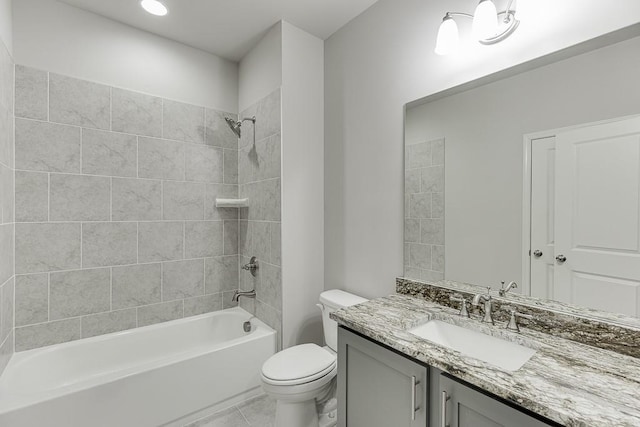 bathroom with vanity, toilet,  shower combination, and tile patterned flooring