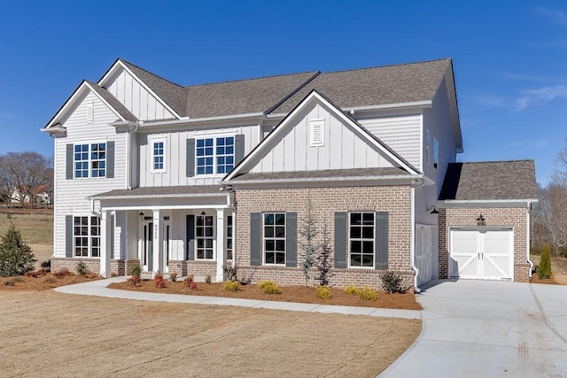 craftsman-style home featuring concrete driveway, a garage, brick siding, and board and batten siding