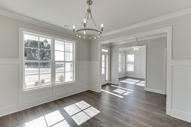 interior space featuring visible vents, ornamental molding, dark wood-style floors, a decorative wall, and a chandelier