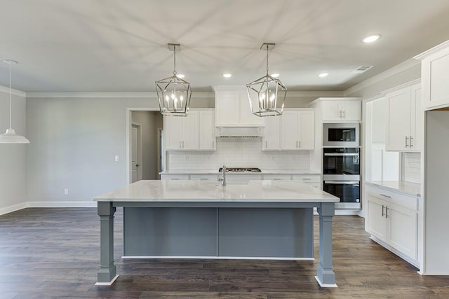 kitchen with visible vents, appliances with stainless steel finishes, dark wood-type flooring, and ornamental molding