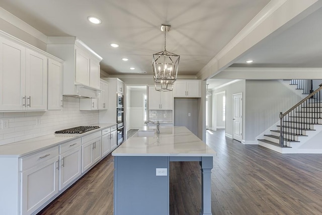 kitchen featuring white cabinetry, dark wood-style floors, stainless steel appliances, and a sink