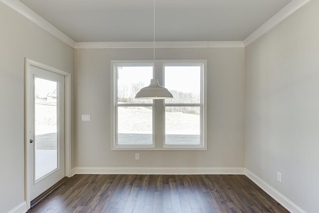 unfurnished dining area with crown molding, dark wood-style floors, and baseboards