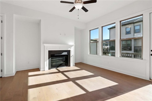 unfurnished living room featuring ceiling fan and dark hardwood / wood-style floors