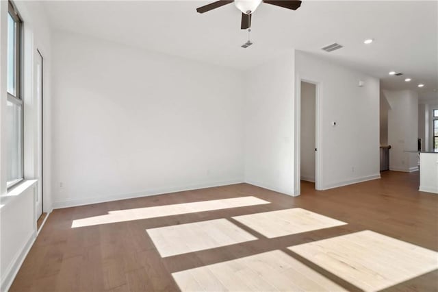 empty room with hardwood / wood-style floors and ceiling fan