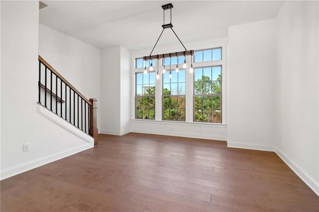 unfurnished dining area with dark hardwood / wood-style flooring