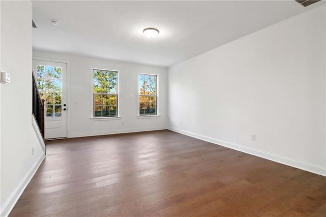 spare room with dark wood-type flooring