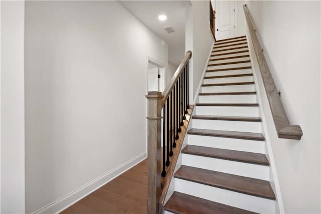 stairs with hardwood / wood-style floors