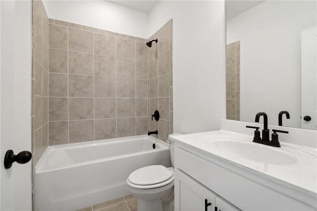 full bathroom featuring vanity, tiled shower / bath combo, and toilet