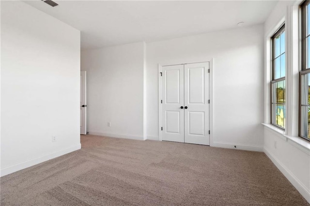 unfurnished bedroom featuring light colored carpet