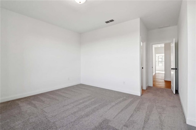 unfurnished room featuring light colored carpet