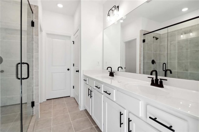 bathroom featuring tile patterned flooring, vanity, and a shower with shower door