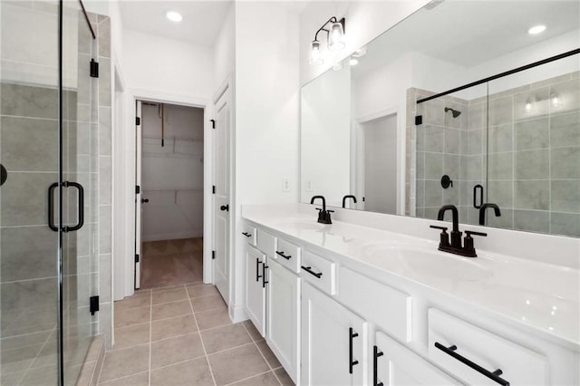 bathroom featuring tile patterned flooring, vanity, and walk in shower