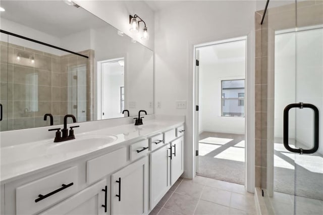 bathroom featuring tile patterned flooring, vanity, and a shower with shower door