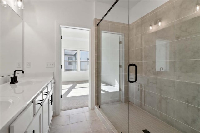 bathroom featuring an enclosed shower, vanity, and tile patterned floors