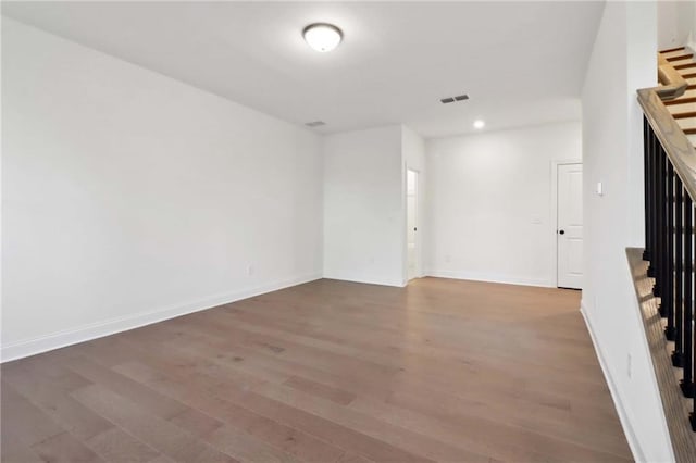 spare room featuring wood-type flooring