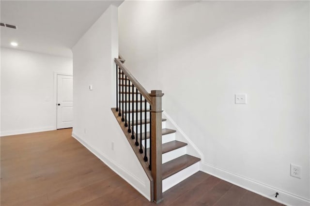 stairs with hardwood / wood-style flooring