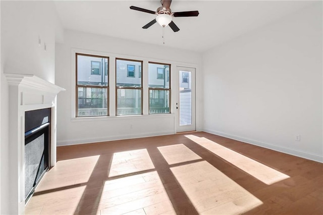 unfurnished living room with light hardwood / wood-style floors and ceiling fan