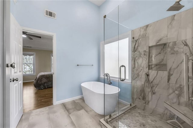 ensuite bathroom with a marble finish shower, visible vents, wood finished floors, a freestanding tub, and baseboards