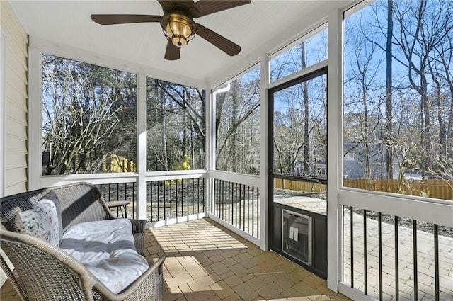 sunroom / solarium with a ceiling fan