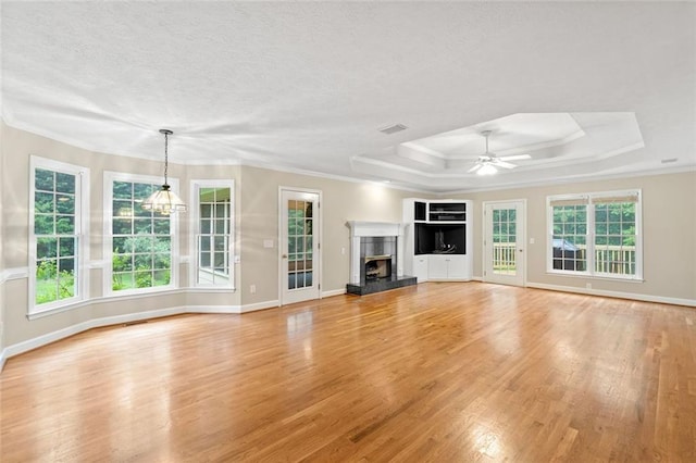 2140 Old Orchard Ln, Canton, GA 30114 - unfurnished living room with light wood finished floors, a raised ceiling, ornamental molding, ceiling fan, and a high end fireplace