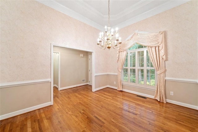 2140 Old Orchard Ln, Canton, GA 30114 - empty room with ornamental molding, wood finished floors, a chandelier, and a tray ceiling