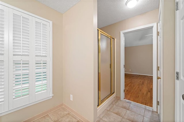 2140 Old Orchard Ln, Canton, GA 30114 - full bathroom with a stall shower, a textured ceiling, and tile patterned flooring