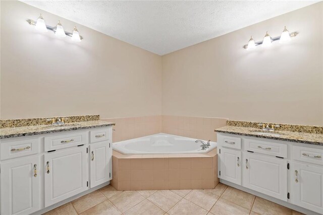 2140 Old Orchard Ln, Canton, GA 30114 - full bathroom featuring vanity, a textured ceiling, a garden tub, and tile patterned floors