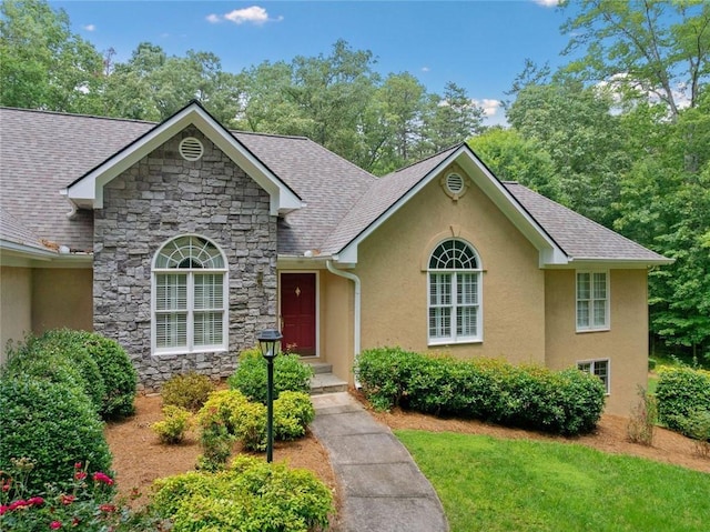 2140 Old Orchard Ln, Canton, GA 30114 - view of front facade featuring stone siding, stucco siding, a front yard, and a shingled roof