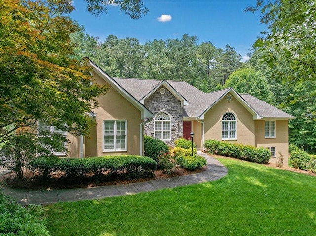 2140 Old Orchard Ln, Canton, GA 30114 - view of front facade featuring stone siding, a front yard, and stucco siding