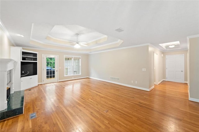 2140 Old Orchard Ln, Canton, GA 30114 - unfurnished living room featuring ornamental molding, a premium fireplace, a ceiling fan, light wood finished floors, and a raised ceiling